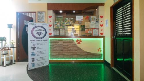 a store front with a green floor and a sign at RedDoorz near SM City Muntinlupa in Manila