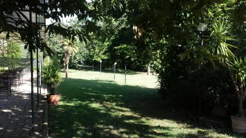 a green park with trees and plants in the shade at Hotel Scilla in Sovana