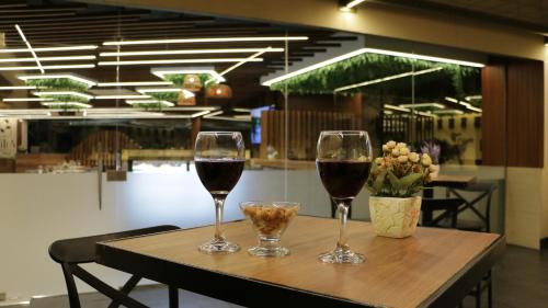 two glasses of wine sitting on a table at Tilia Hotel Beirut in Beirut