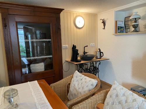 a room with a table and a clock on the wall at Ferienhaus Meixner in Riedenburg
