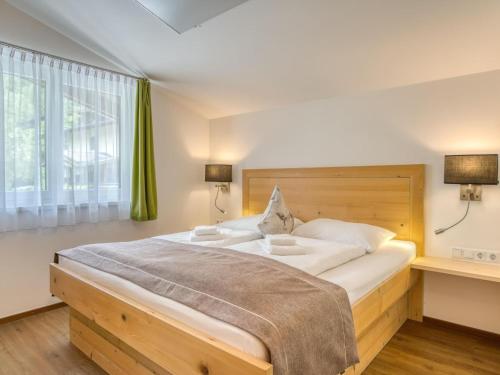a bedroom with a large bed and a large window at Chalet in Neukirchen with Mountain Views in Rosenthal