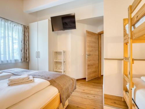 a bedroom with a bed and a bunk bed at Chalet in Neukirchen with Mountain Views in Rosenthal