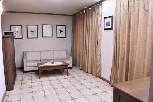 a living room with a couch and a table at Sunjin Grand Hotel in Ulaanbaatar