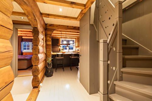 a hallway of a tiny house with a kitchen and stairs at Luxurious and modern log cabin close to nature in Lislevatn