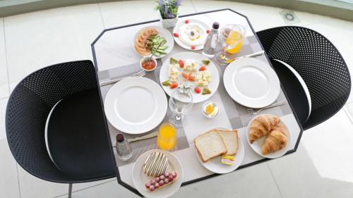 a table with plates of food on it at Tilia Hotel Beirut in Beirut