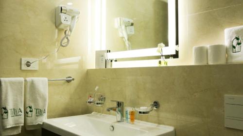 a bathroom with a sink and a mirror at Tilia Hotel Beirut in Beirut