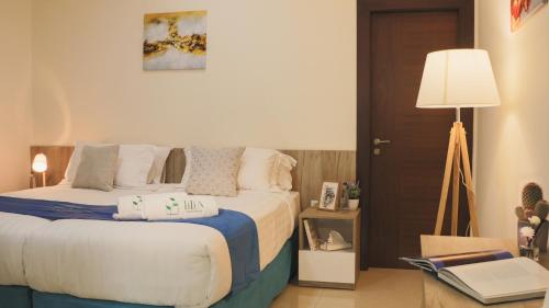 a bedroom with a bed with pillows on it at Tilia Hotel Beirut in Beirut