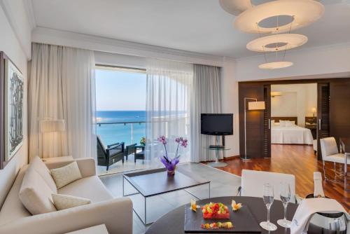 a living room with a view of the ocean at Elysium Resort & Spa in Faliraki