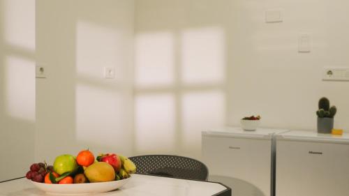 a bowl of fruit on a table in a kitchen at Tilia Hotel Beirut in Beirut