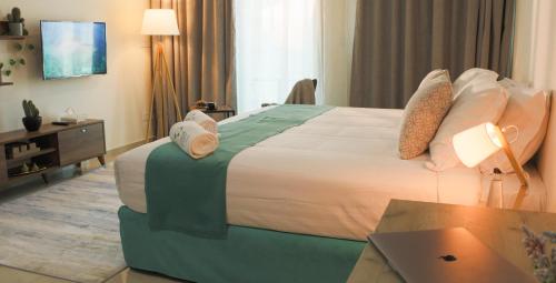 a hotel room with a large bed and a desk at Tilia Hotel Beirut in Beirut