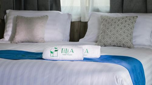 a bed with two towels on top of it at Tilia Hotel Beirut in Beirut