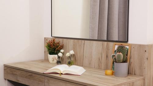 a wooden table with a book and a book at Tilia Hotel Beirut in Beirut