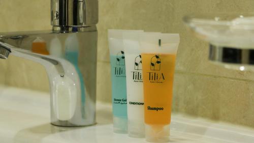 a bottle of sunscreen sitting on top of a sink at Tilia Hotel Beirut in Beirut