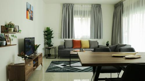 a living room with a couch and a table at Tilia Hotel Beirut in Beirut
