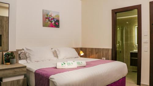a bedroom with a bed with two pillows on it at Tilia Hotel Beirut in Beirut