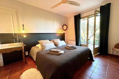 a bedroom with a bed with a black headboard at Bastide dou Pastre Family friendly house with amazing view in Mérindol