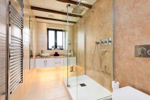 a bathroom with a shower and a sink at Finest Retreats - Flint Barn in Faversham