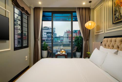 Bella Rosa Hotel & Travel في هانوي: غرفة نوم بسرير كبير ونافذة كبيرة