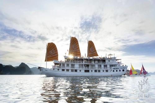 a cruise ship with sails in the water at Hera Cruises Group on Ha Long Bay in Ha Long