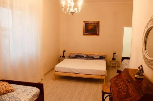 a bedroom with a bed and a mirror at Maison Luigi - Casa Vacanze3 in Nociglia