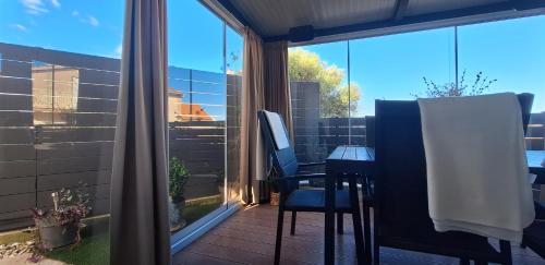 a balcony with a table and chairs and a window at Apartman Barry in Primošten