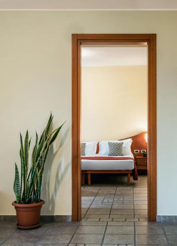 a bedroom with a bed and a mirror at Hotel La Fenice in Castel di Sangro