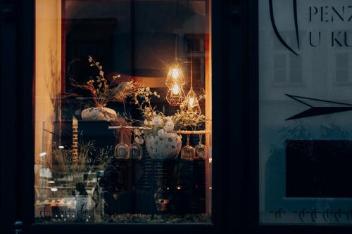 a window of a store with vases and flowers at Penzion U Kubesa - Adults only in Kroměříž