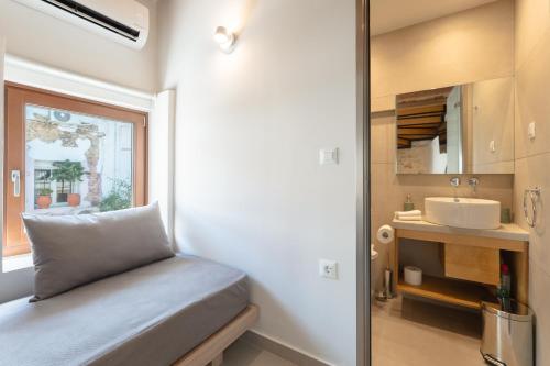 a small bedroom with a sink and a mirror at Casa Di Sabbia in Chania Town