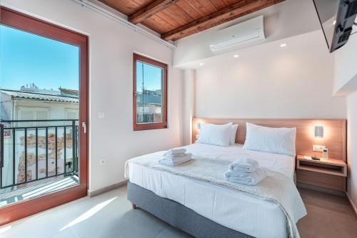a bedroom with a bed and a large window at Casa Di Sabbia in Chania Town