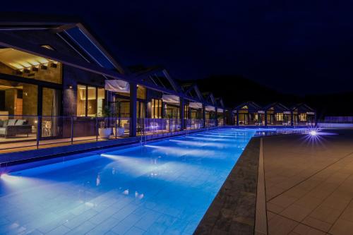 a large swimming pool at night with buildings at FIVE SPRING RESORT THE SHIRAHAMA in Shirahama