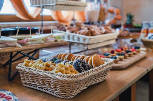 a buffet line with baskets of pastries and other desserts at Hotel La Fenice in Castel di Sangro