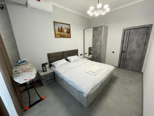 a bedroom with a large bed and a mirror at Art Hotel Navoiy in Navoi