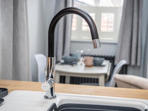 a kitchen sink with a faucet on a counter at The Sands Sheringham in Sheringham