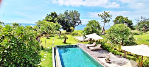 an image of a swimming pool at a resort at JOGLO APONG Beachfront Apartment in Tegallengah