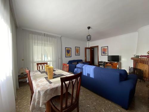 een woonkamer met een blauwe bank en een tafel bij Apartamentos "Un Rico Domingo" in Torrox Costa