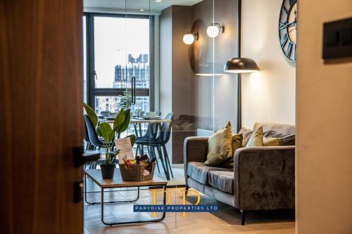 a living room with a couch and a table at Mancunian Luxury Suite - Stylish & Warm 1-Bed - Ideal For Business or Work Stays - By Parydise Properties in Manchester