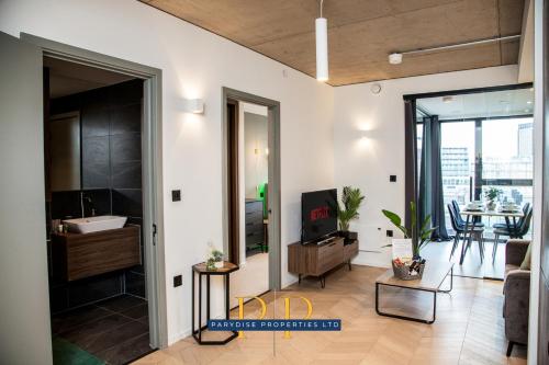 a living room with a couch and a table at Mancunian Luxury Suite - Stylish & Warm 1-Bed - Ideal For Business or Work Stays - By Parydise Properties in Manchester