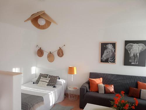 a living room with a couch and a chair at Apartamento entero con jardín en Casa Amelia in Padrón
