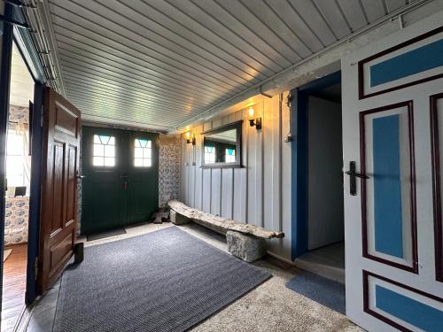 a hallway of a house with a door and a rug at Huus Hannchen in Langeneß