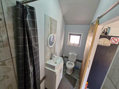 a small bathroom with a toilet and a sink at Vosloo's rest in Vereeniging