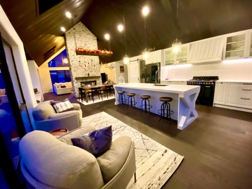 a kitchen and living room with a couch and a table at Luxury Alpine Retreat with a hot tub in Frankton