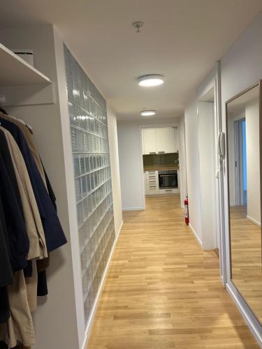 a hallway with a walk in closet with wooden floors at Dokkeveien Apartment in Bergen