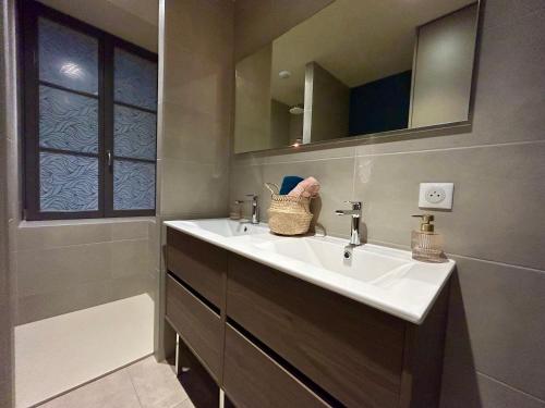 a bathroom with a sink and a mirror at Antica Stazione in Guebwiller