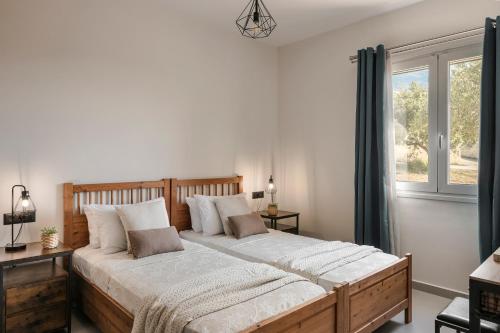 duże łóżko w sypialni z oknem w obiekcie Defamelia Villa w mieście Kefalonia