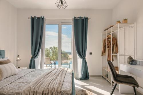 sypialnia z łóżkiem i przesuwnymi szklanymi drzwiami w obiekcie Defamelia Villa w mieście Kefalonia