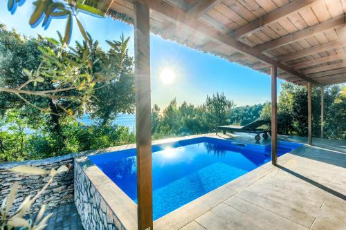 an infinity pool in a villa with a view at Golden Haven Luxe Bungalow Resort in Murter