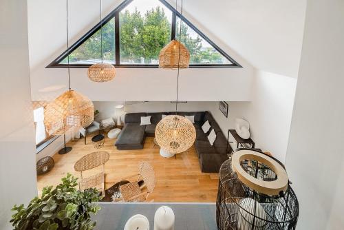 an attic living room with a large window at CLOS HILY - Maison d'exception à Dinard - 10 pers in Dinard