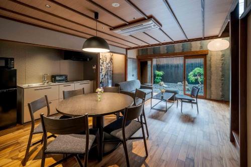 a kitchen and dining room with a table and chairs at Matsunoma Machiya House in Kanazawa