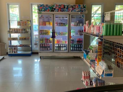 a store with a refrigerator filled with lots of drinks at กิจตรงวิลล์ รีสอร์ท Kittrongvill in Ubon Ratchathani