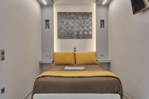 a bed in a room with a painting on the wall at Modern Studio for Two, Mytilene Lesvos in Mytilene